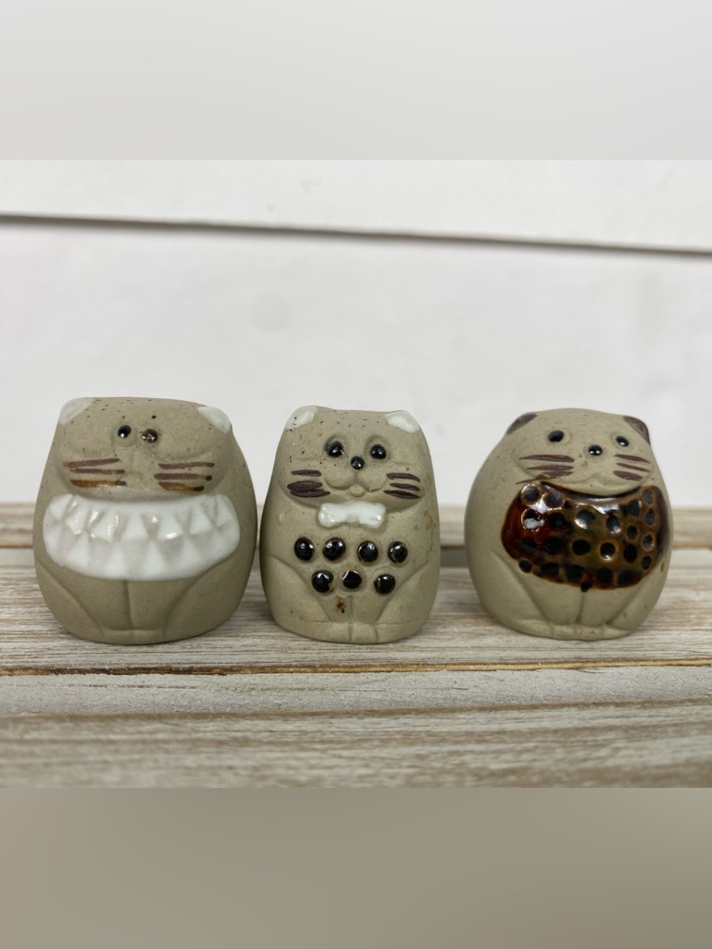 Cats 3 small handcrafted ceramic figurines  distinct designs on their bellies.